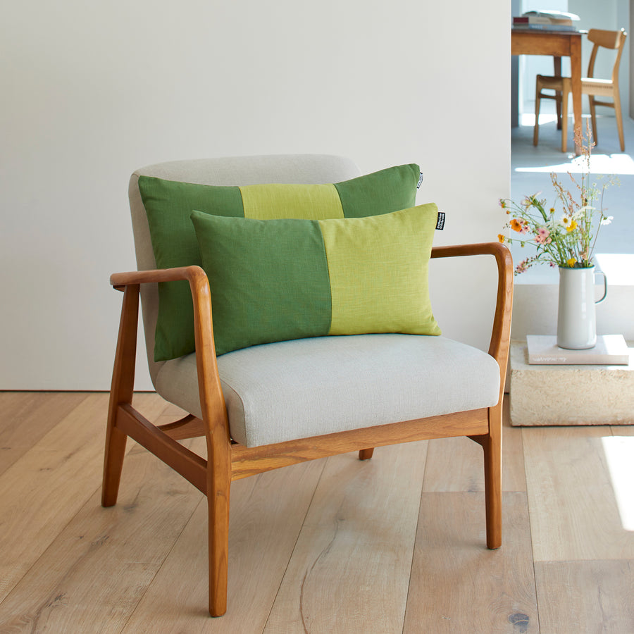 CATHERINE COLEBROOK DOUBLE COLOUR BLOCK OLIVE CHARTREUSE CUSHION ON A CHAIR