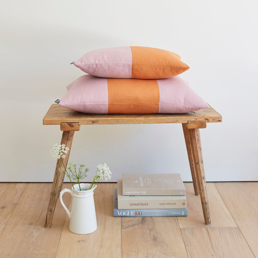 CATHERINE COLEBROOK DOUBLE COLOUR BLOCK DENIM JUNGLE CUSHION ON A BENCH