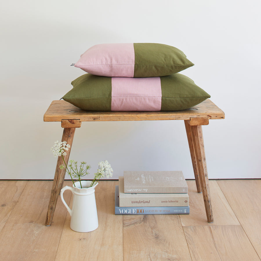 CATHERINE COLEBROOK DOUBLE COLOUR BLOCK DUSKY JUNGLE CUSHION ON A BENCH